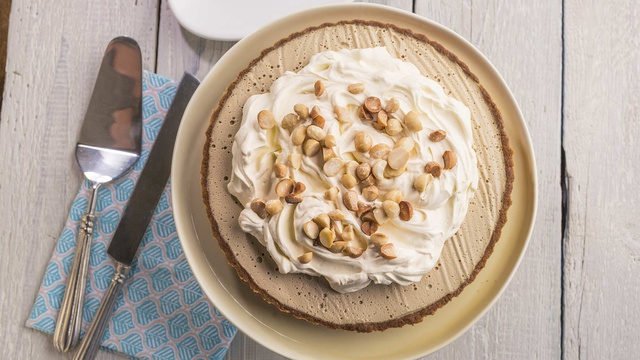 Arial view of butterscotch tart with curry shortbread crust served with whipped cream and macadamia nuts